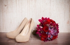 16957626 - beautiful wedding bouquet of red roses and the bride shoes