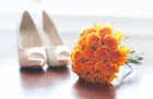 18976939 - wedding shoes and bouquet of orange roses nobody