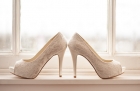 18976951 - high healed wedding shoes on a windowsill by a window