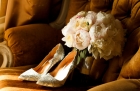 87873715 - bridal bouquet with wedding shoes