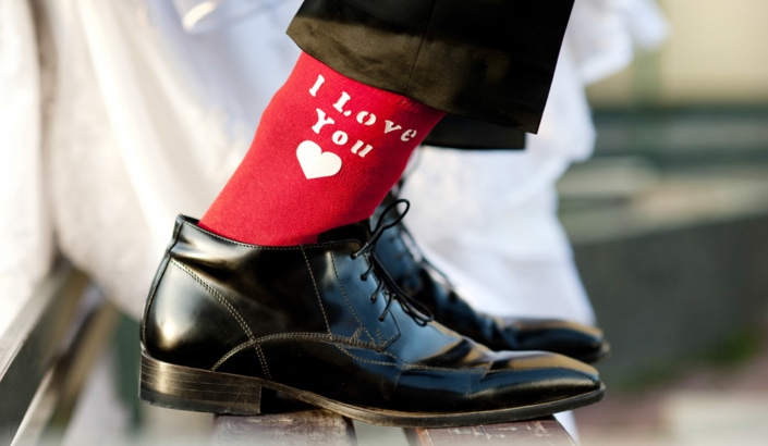 20644629 – groom s funny feet with love sign on red socks